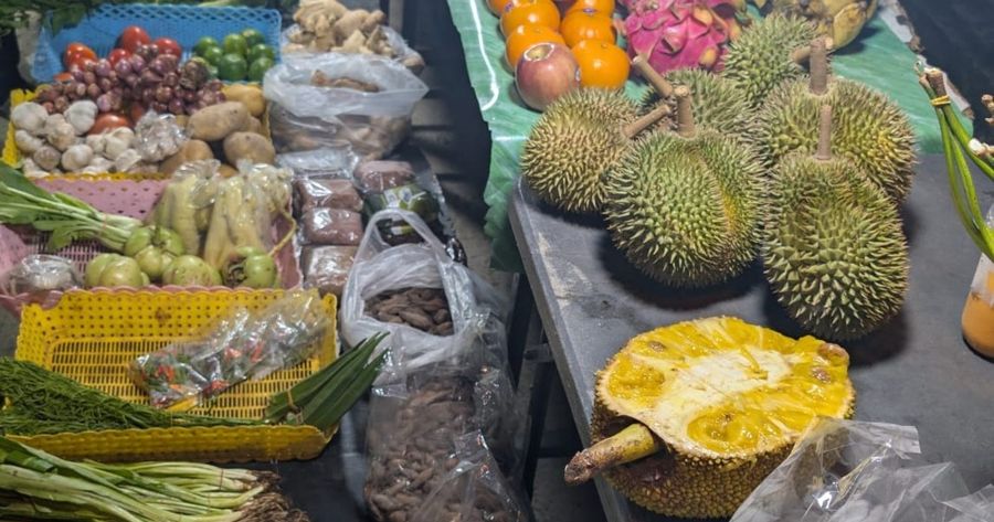 Marktstand mit Durian, Jackfrucht, Gemüse und Thai-Kräutern